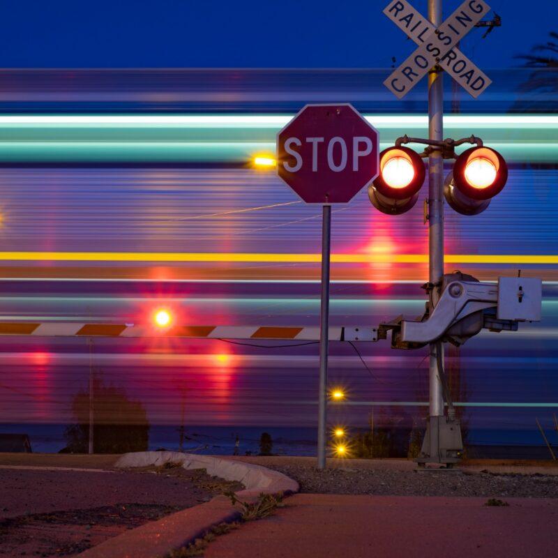 Stop sign by railroad tracks.